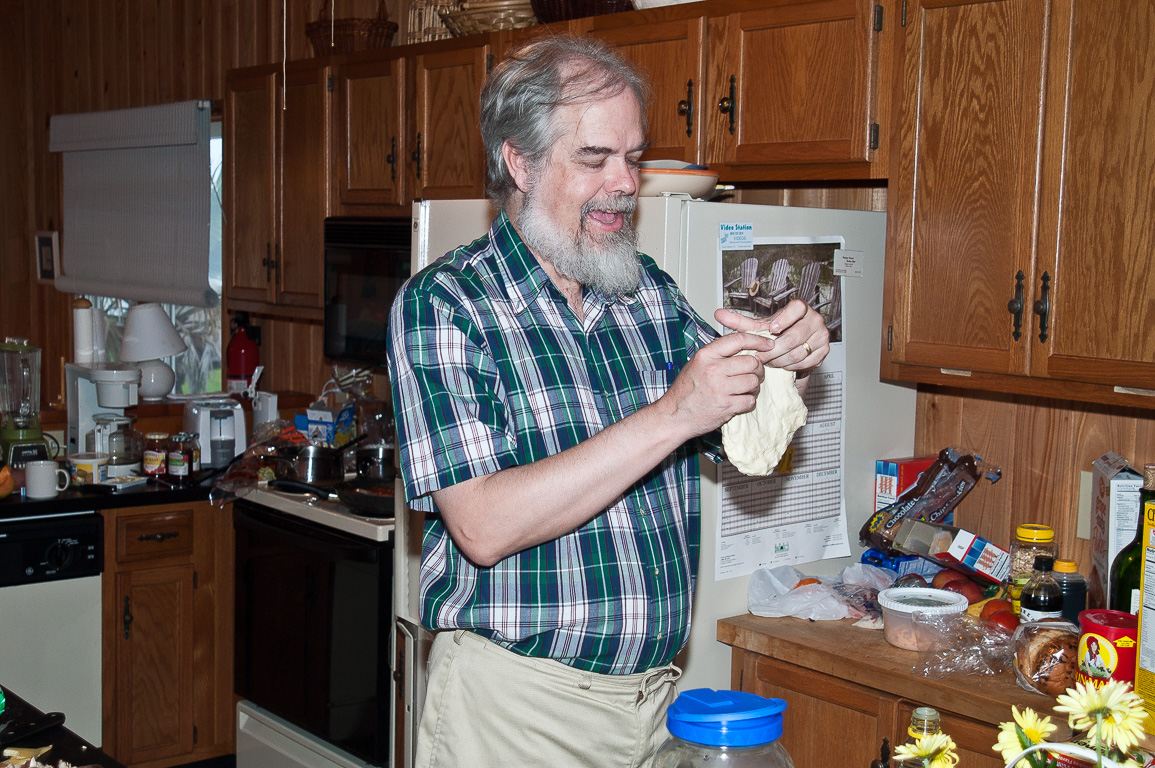 George is making pizza from scratch